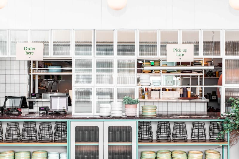 Restaurant service counter with stacked crockery and pick-up signs