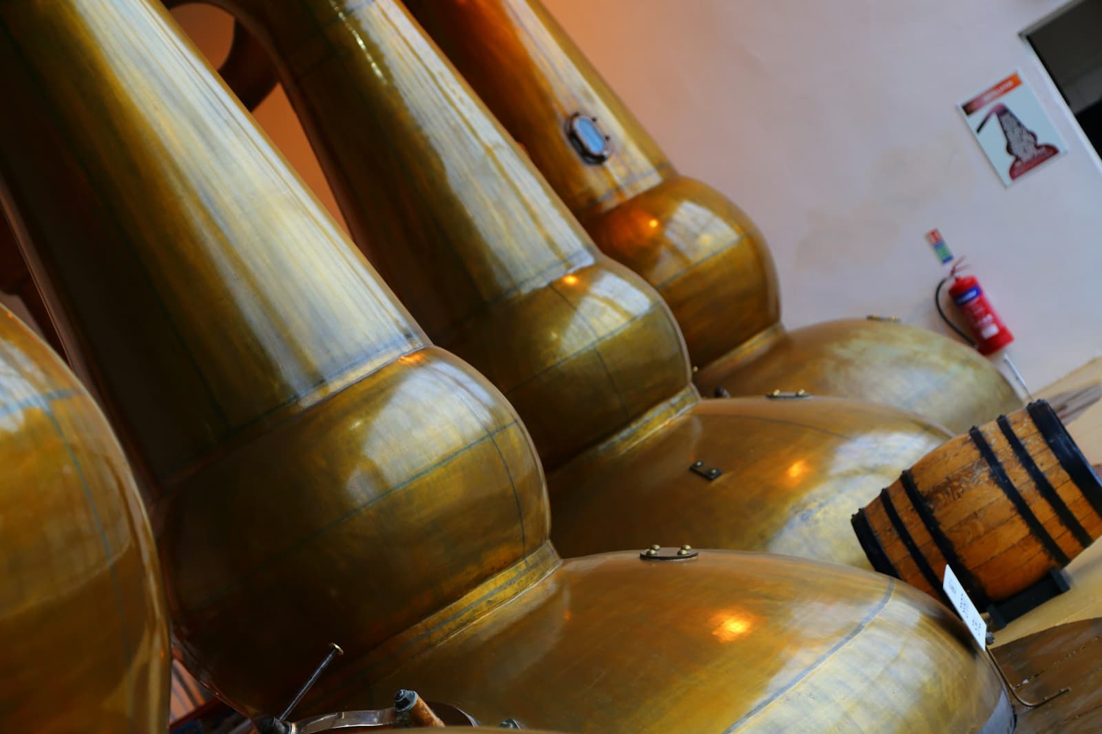 Copper pot stills inside a small Scottish whisky distillery production room