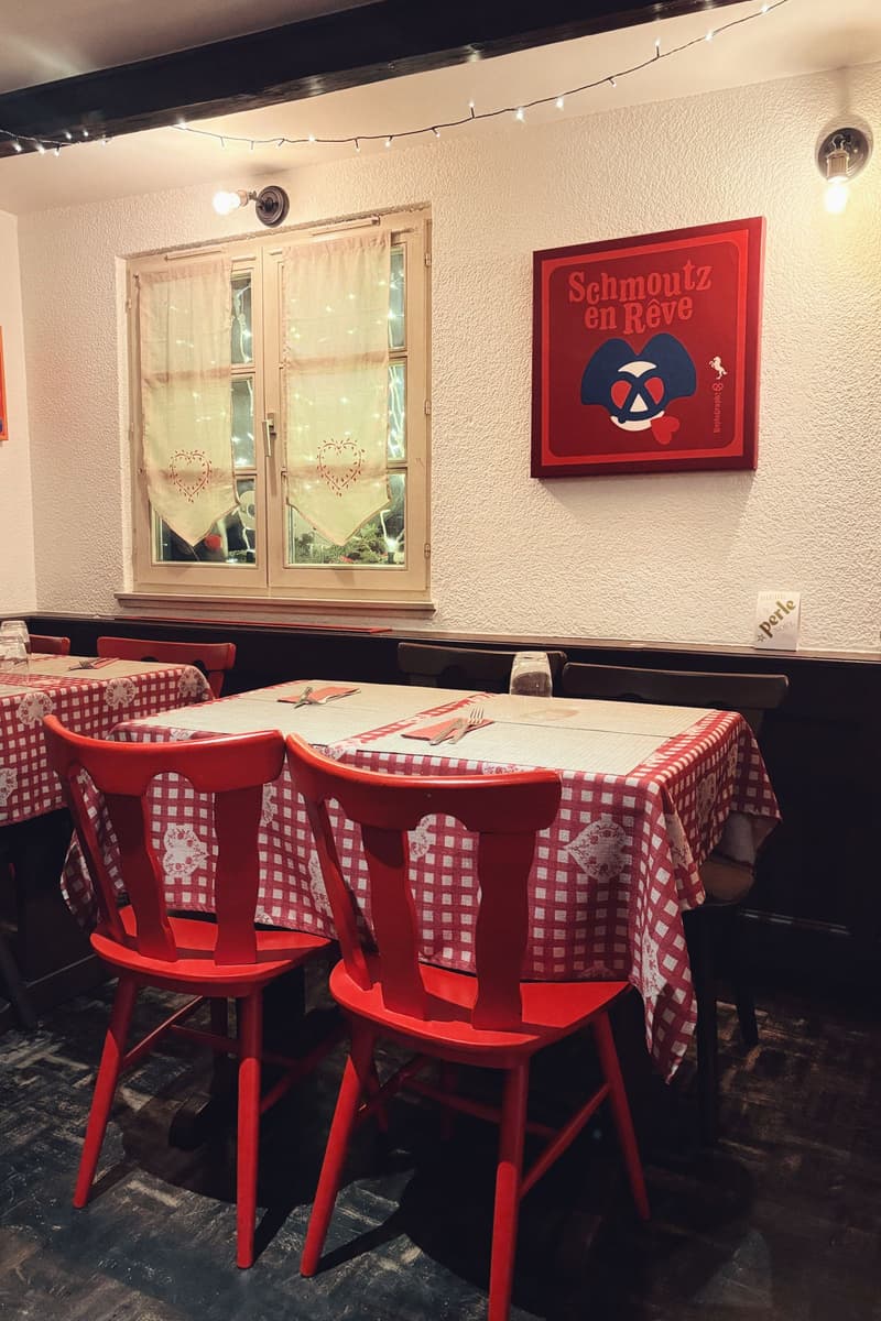 Cosy French bistro dining room with red checked tablecloths and red chairs