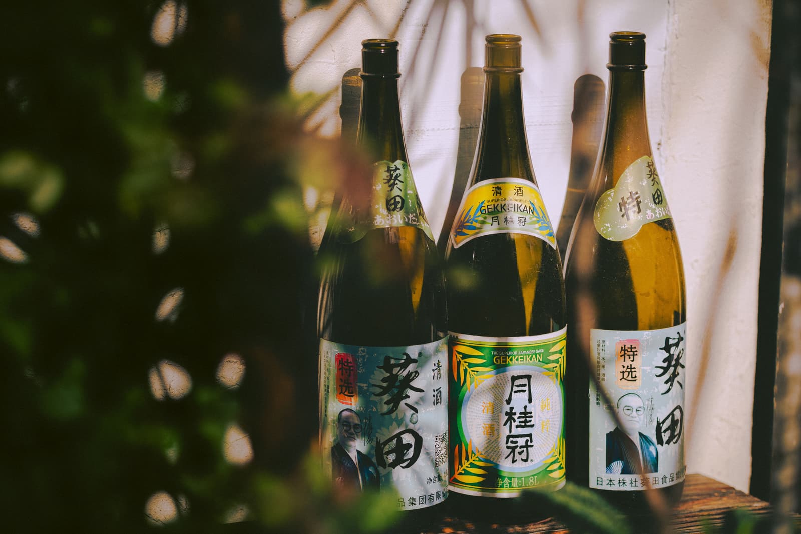 Traditional Japanese sake bottles with labels in natural light