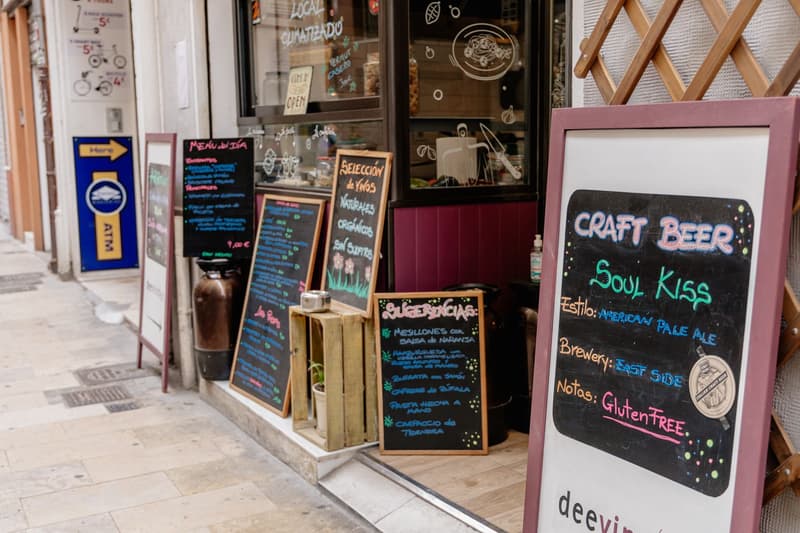 Chalkboard menus, including a menú del día, outside a café on a Valencia street
