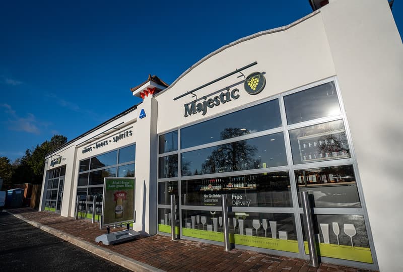 Storefront of a Majestic Wine shop in Beckenham with glass windows and a green wine, beers and spirits band