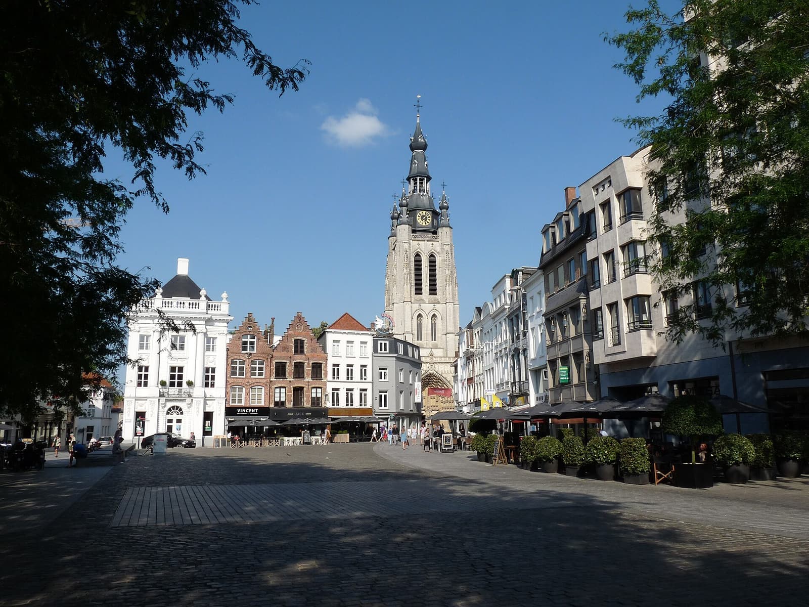 Kortrijk's main square with cafe terraces and the tower of St Martin's church